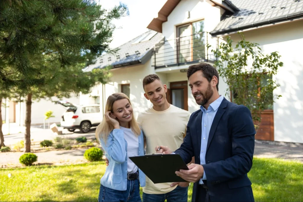 Real estate agent with a couple about to sign their new home.